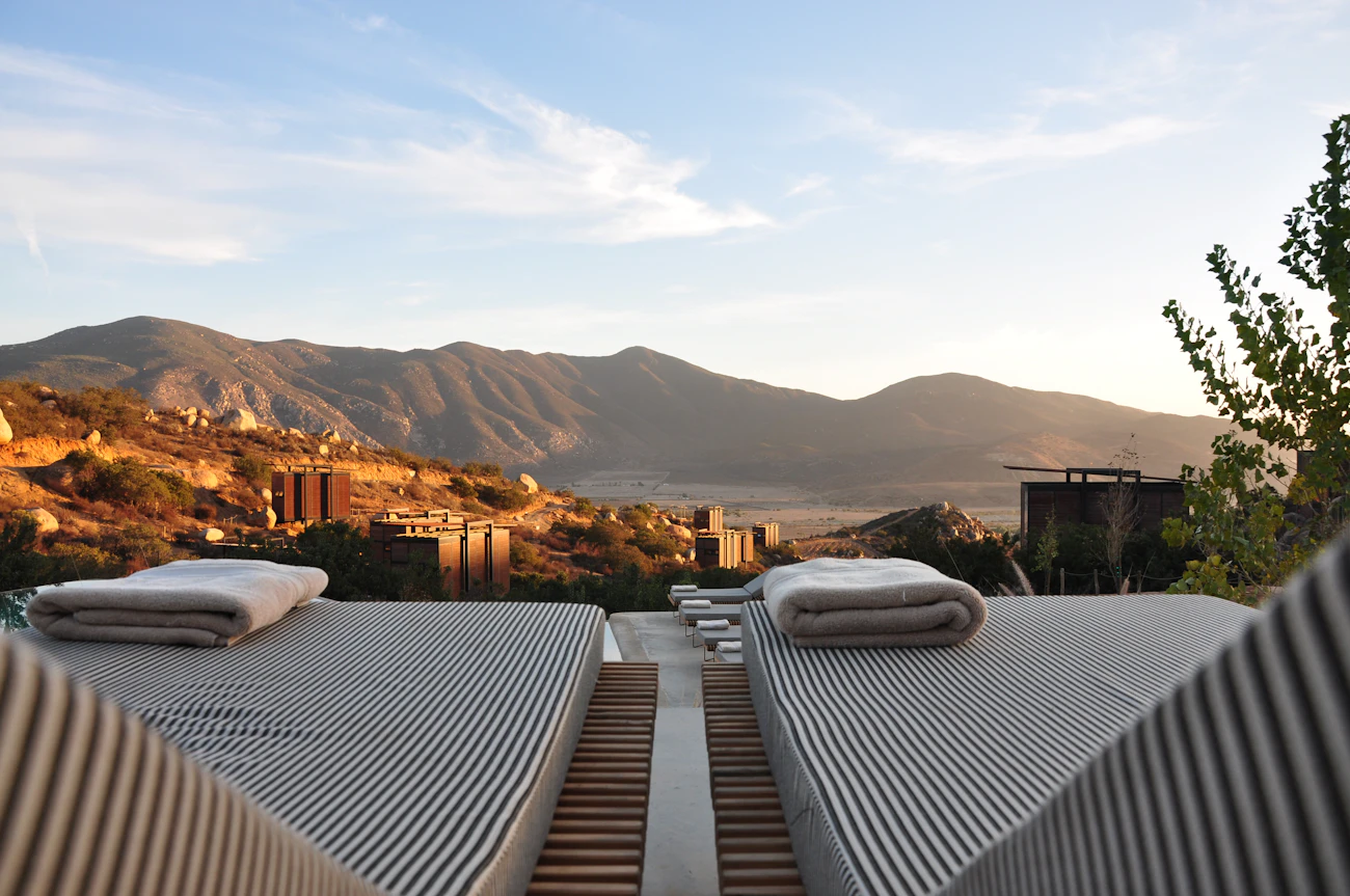 A terrace with loungers looking over evening hills