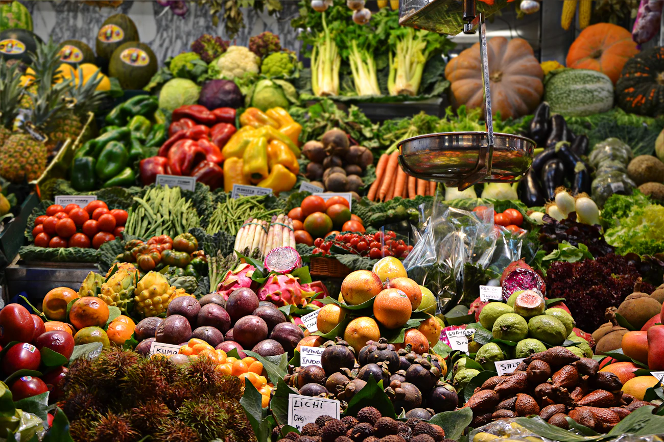 A market stall piled with fruit and vegetables