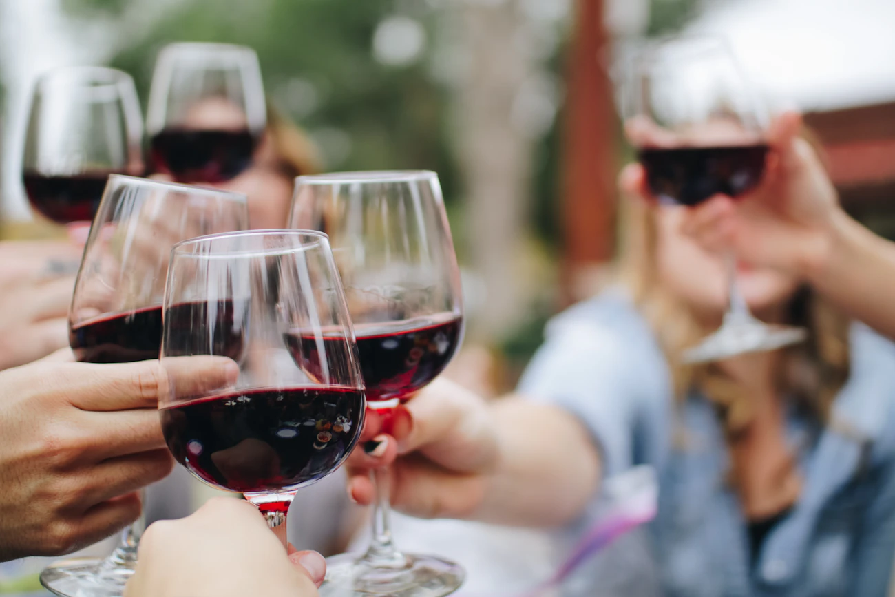 Glasses of red wine raised in a toast