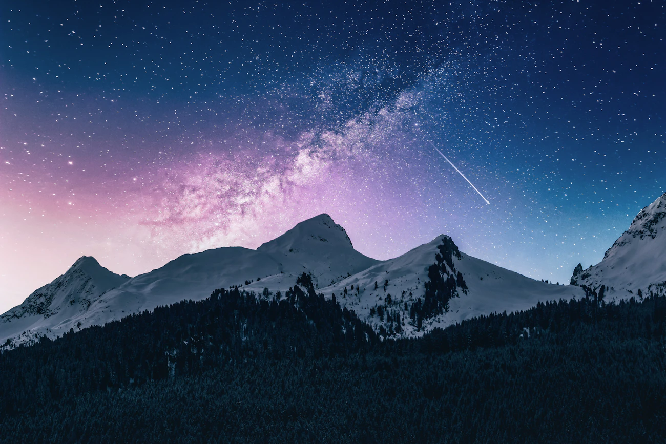 Mountains under a starry night sky