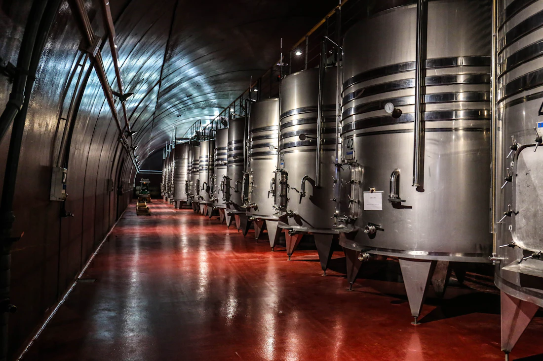 Wine being poured in a dim cellar