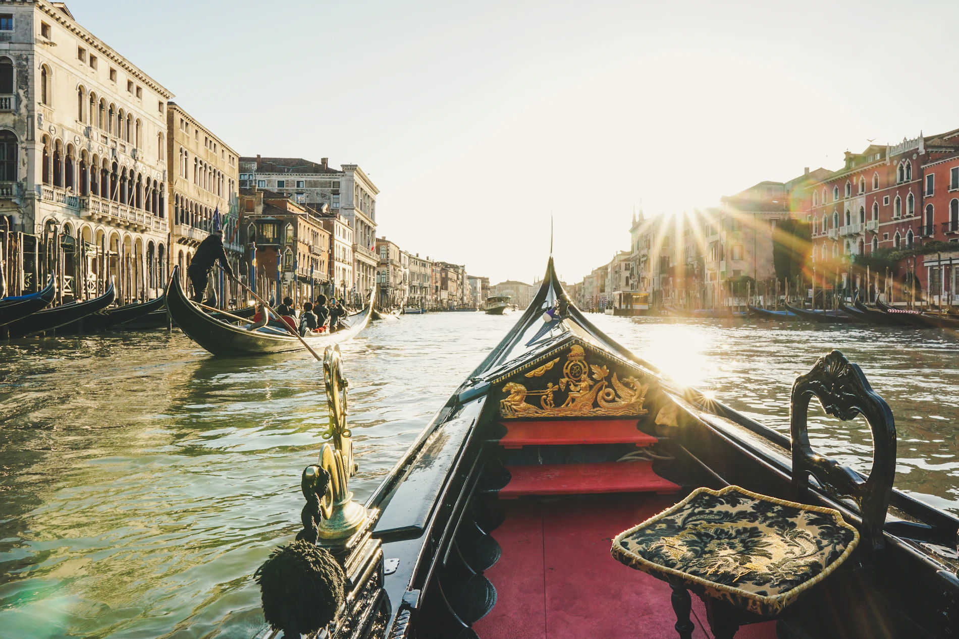A gondola on a Venetian canal at sunrise