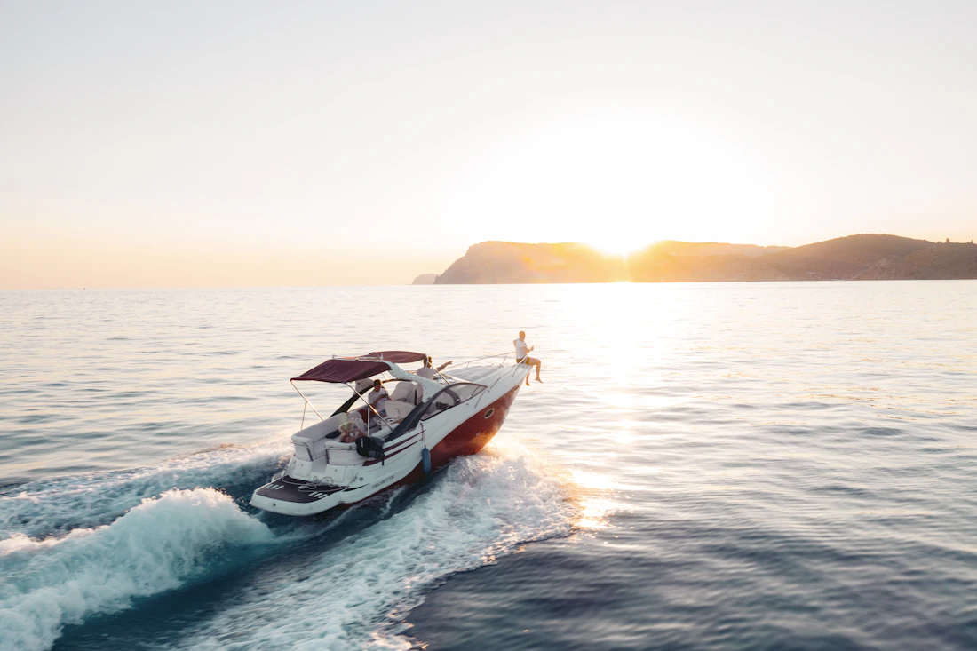 A boat's wake glowing in the sunset