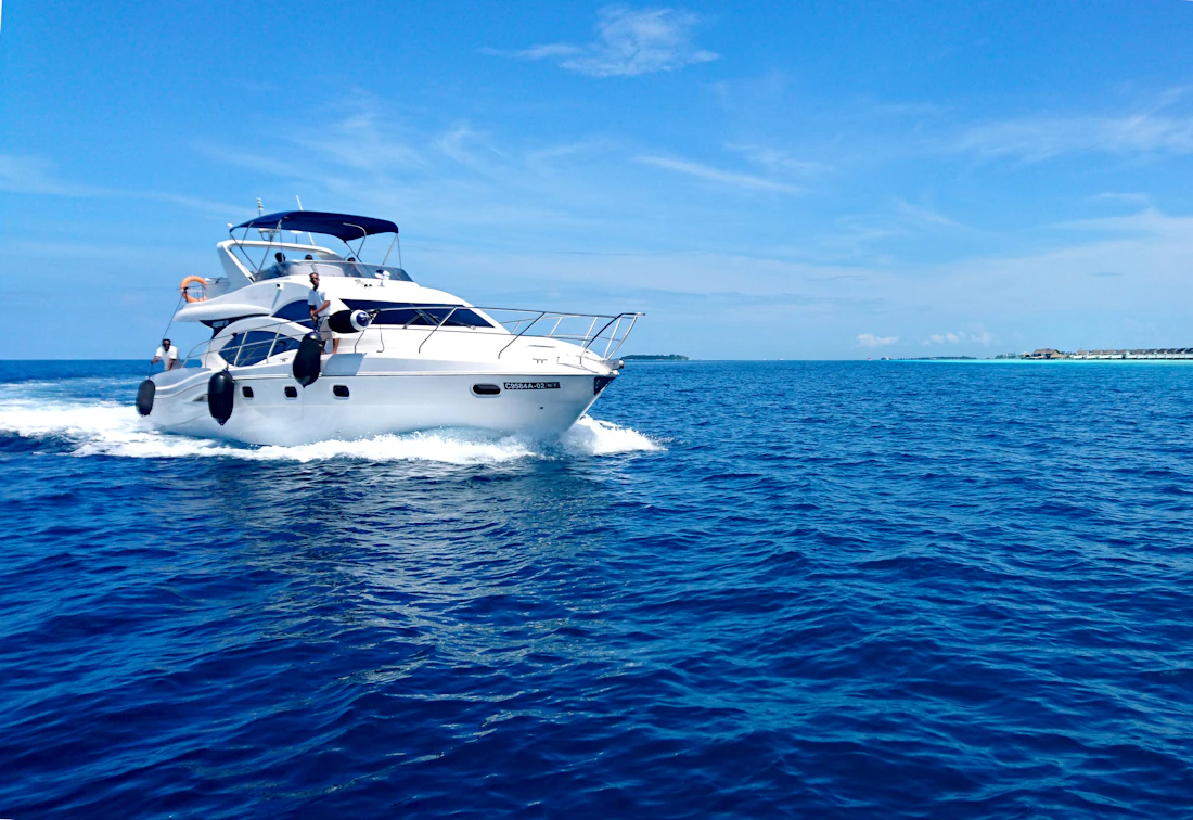 A private launch cutting across deep blue water