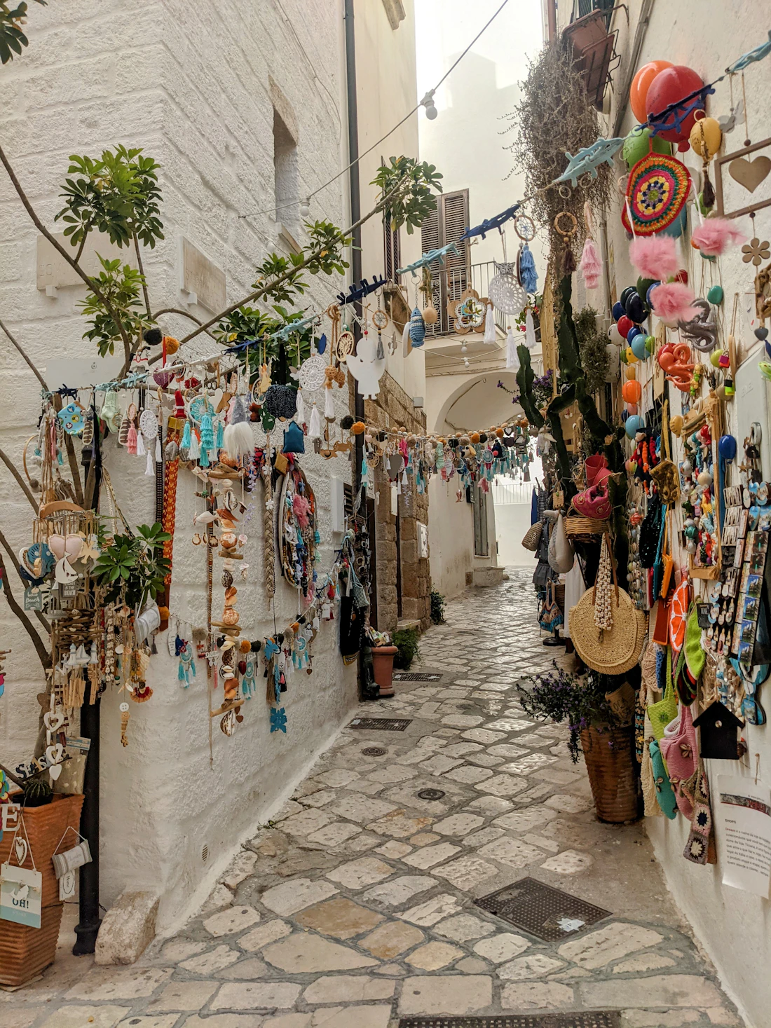 A narrow southern lane hung with ceramics and colour