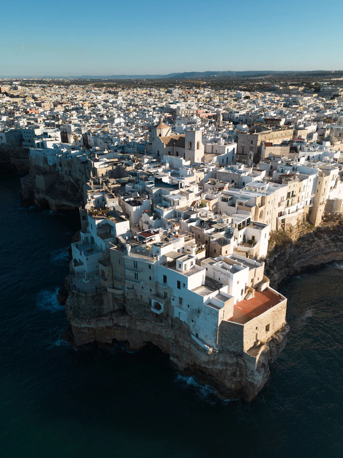 Whitewashed rooftops of a Puglian hill town from above