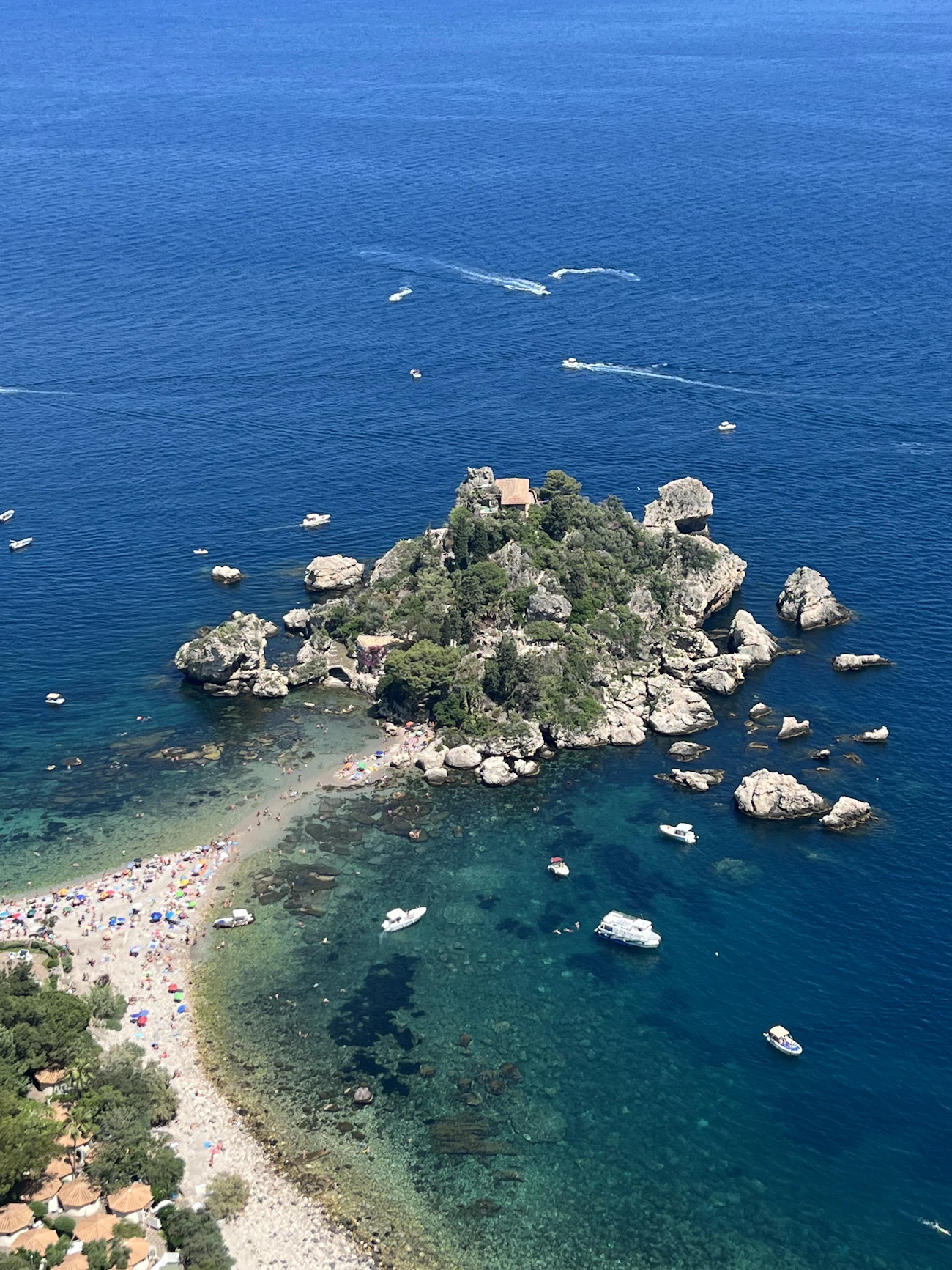 The green islet of Isola Bella ringed by clear water