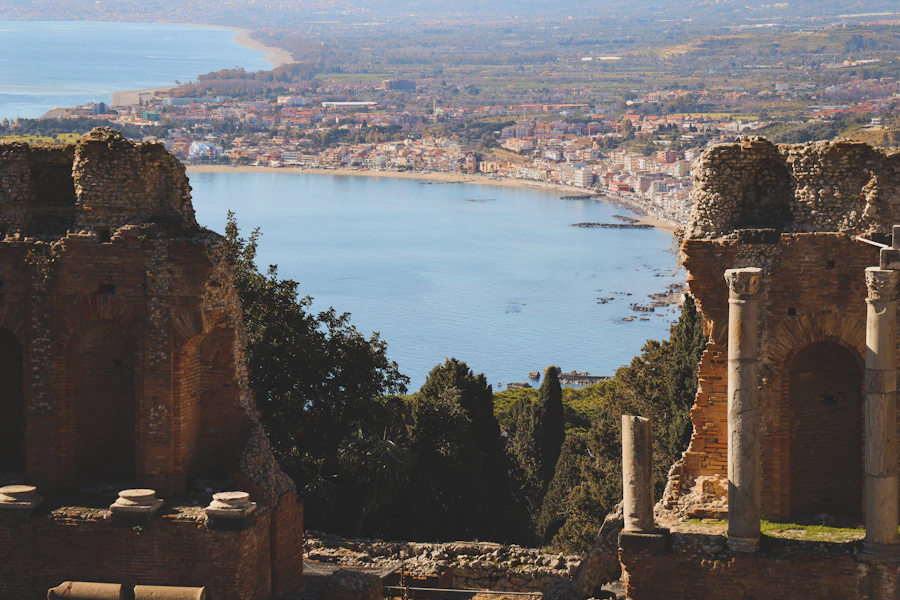 Greek theatre columns framing the bay of Taormina in Sicily